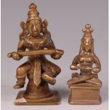 An Indian brass shrine deity figure of Annapurna Devi, in seated pose holding ladle of plenty, h.