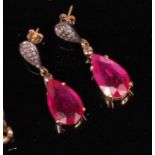 A pair of ladies silver gilt ruby and diamond ear pendants, each pear cut ruby weighing approx. 5ct,