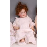 An SFBJ of Paris bisque head doll, having rolling eyes, painted features, composition body, marked