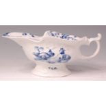 An early Worcester porcelain sauceboat, relief moulded and underglaze blue decorated with