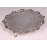 An early George III silver card waiter, having a raised piecrust rim, engraved ground, and on