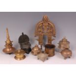 An Indian bronze shrine stand, brass prabha of good size, and seven various brass pots/inkwells,