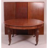 A Victorian mahogany extending dining table, having pull-out action, three extra leaves,