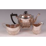 An Edwardian silver three piece teaset, comprising; teapot, twin handled sugar and cream,