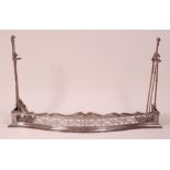 A George III steel fire fender with companion set, having a pierced and wavy frieze,
