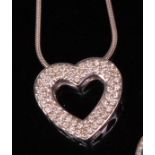 A contemporary 14ct gold and diamond set openwork pendant, of heart shape,