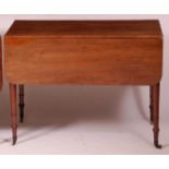 An early 19th century mahogany Pembroke table, the top having rounded corners,