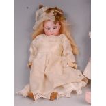 A Simon & Halbig 1079 DEP bisque headed doll, having rolling blue eyes, painted features,