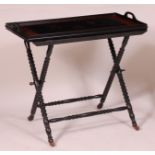 A 19th century continental walnut and ebonised butlers tray on stand, the top with three marquetry