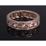 An early 20th century platinum and diamond eternity ring,