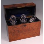 A Victorian figured walnut decanter box, the hinged cover having inset monogrammed brass plaque,