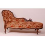 A Victorian walnut chaise-longue, the showframe with applied scroll mouldings,