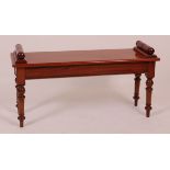 A Victorian style mahogany window seat, having turned ends and on ring turned tapering supports, w.