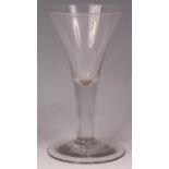 An 18th century drawn trumpet wine glass, of good size, raised on a conical flaring foot, h.25cm