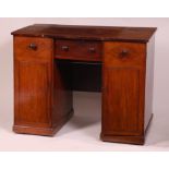 An antique mahogany kneehole desk,