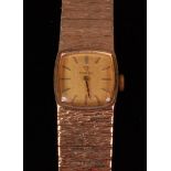 An Omega ladies 9ct gold bracelet watch, having a signed square dial with baton markers,