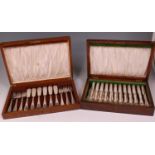 A fitted oak canteen of twelve dessert knives and forks,