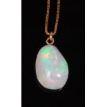 A heavy polished opal pendant, on 18ct finelink neckchain,