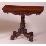 A Victorian rosewood pedestal card table, having a D-shaped fold-over top with swivel action,