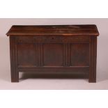 A late 17th century joined oak three panel coffer, the hinged lid on loop hinges, having low