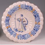 An 18th century Dutch Delft lobed charger, underglaze decorated in shades of blue, yellow and