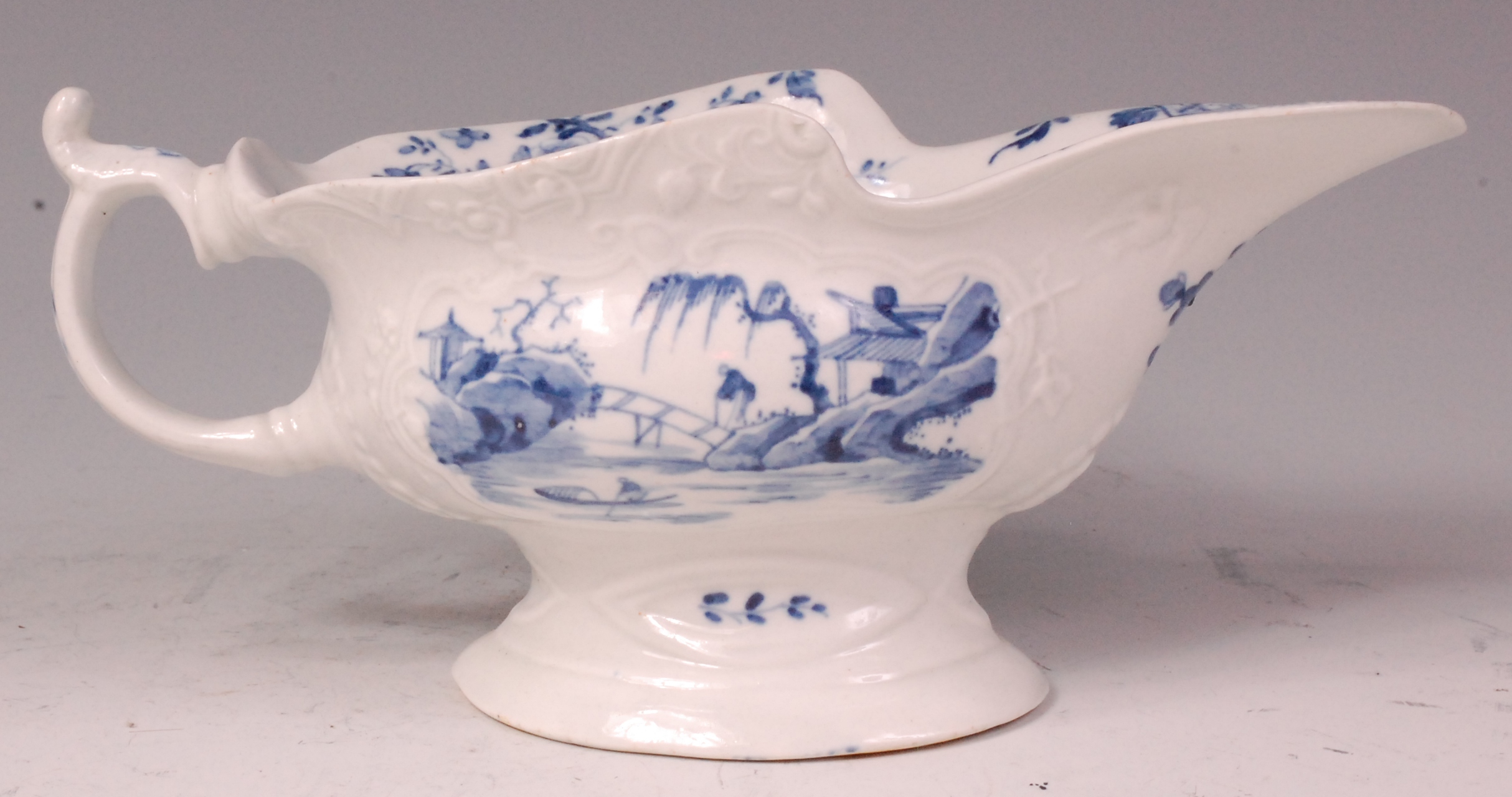 An early Worcester porcelain sauceboat, relief moulded and underglaze blue decorated with - Image 3 of 6