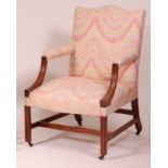 A George III mahogany framed Gainsborough armchair, re-upholstered, having moulded downswept arms,