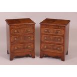 A pair of figured walnut three drawer bedside chests,