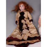 An Armand Marseille 370 bisque headed doll, having fixed brown eyes, painted features and fabric