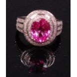 A contemporary 14ct white gold pink sapphire and diamond set ladies dress ring,