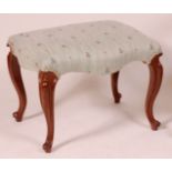 A Victorian walnut dressing stool, having stuffover seat raised on French cabriole supports, w.
