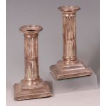 A pair of Edwardian silver candlesticks,