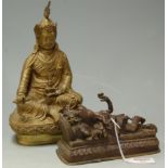 A Far Eastern brass seated deity;