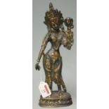 A Far Eastern brass standing deity