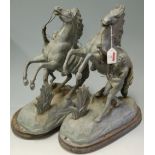 A pair of spelter figures of Marley horses and horsemen