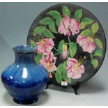 A large mid-20th century charger, with floral decoration,