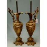 A pair of early 20th century gilt metal lamp bases in the form of a classical ewer