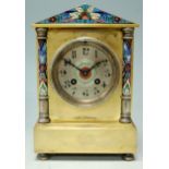 A late 19th century brass cased and enamelled mantel clock having a silvered dial with arabic