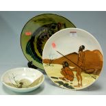 A mid-20th century pottery plate depicting an aboriginal scene inscribed verso Martin Boyd,