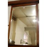 An Edwardian walnut overmantel mirror,
