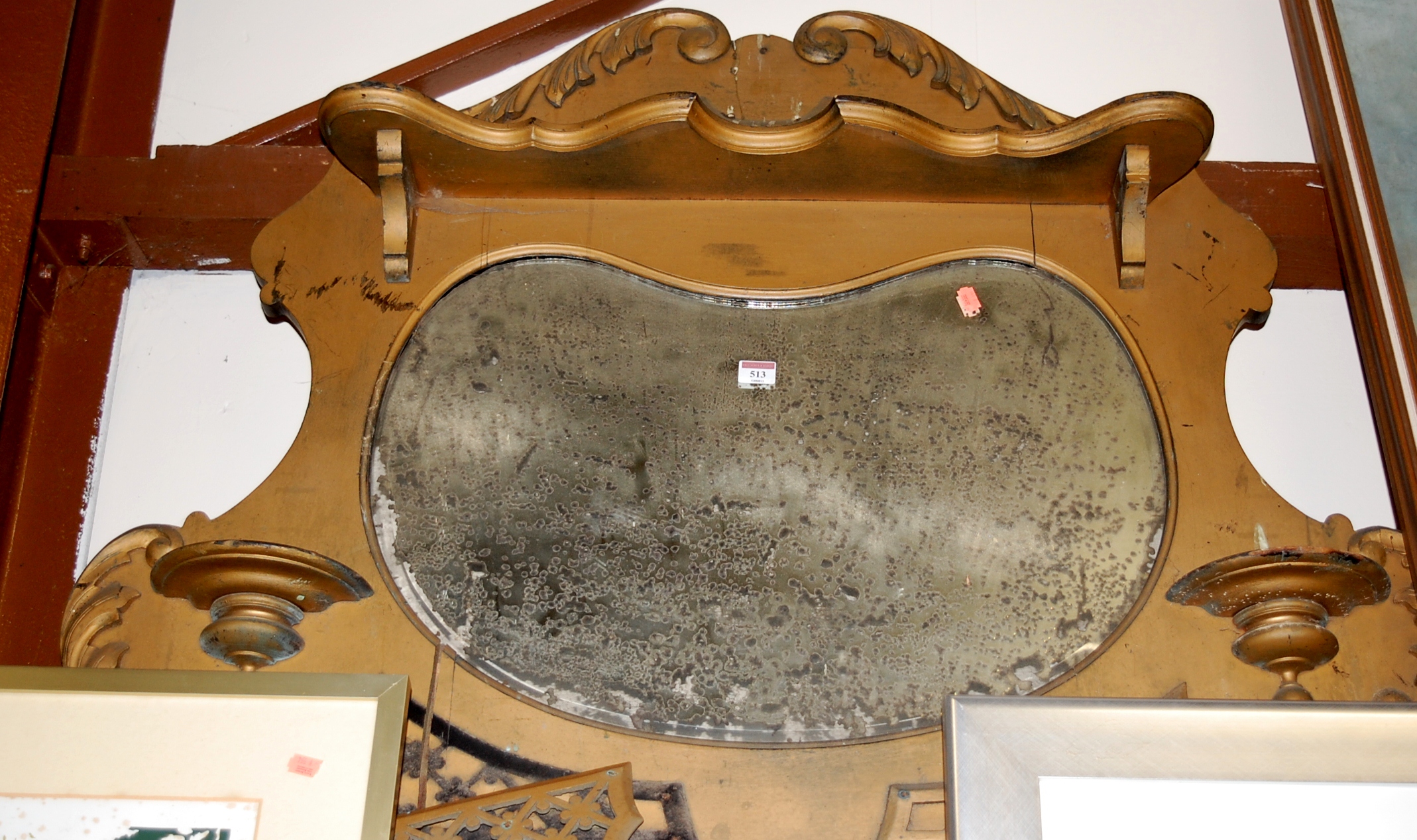 An early 20th century gilt overmantel mirror (a/f - with extensive silvering)