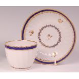 An early 19th century Derby porcelain tea bowl on stand, both of fluted circular form with cobalt