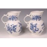 A pair of first period Worcester porcelain mask jugs, each underglaze blue printed with sprays of