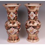 A pair of 19th century soft-paste porcelain vases, in the Derby style, each decorated with sprays of