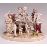 A German porcelain table centrepiece Bacchanal figure group, the whole raised on oval floral