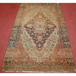 A Persian woollen Sarouk rug, having a centre lozenge medallion within trailing flowers and