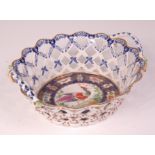 An 18th century Bow porcelain basket, lattice worked and with applied ropetwist handles and flower