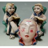 A pair of pottery figural book-ends,