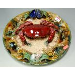 A large Palissy style majolica plate surmounted by a crab