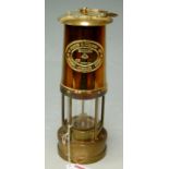A reproduction brass miners safety lamp